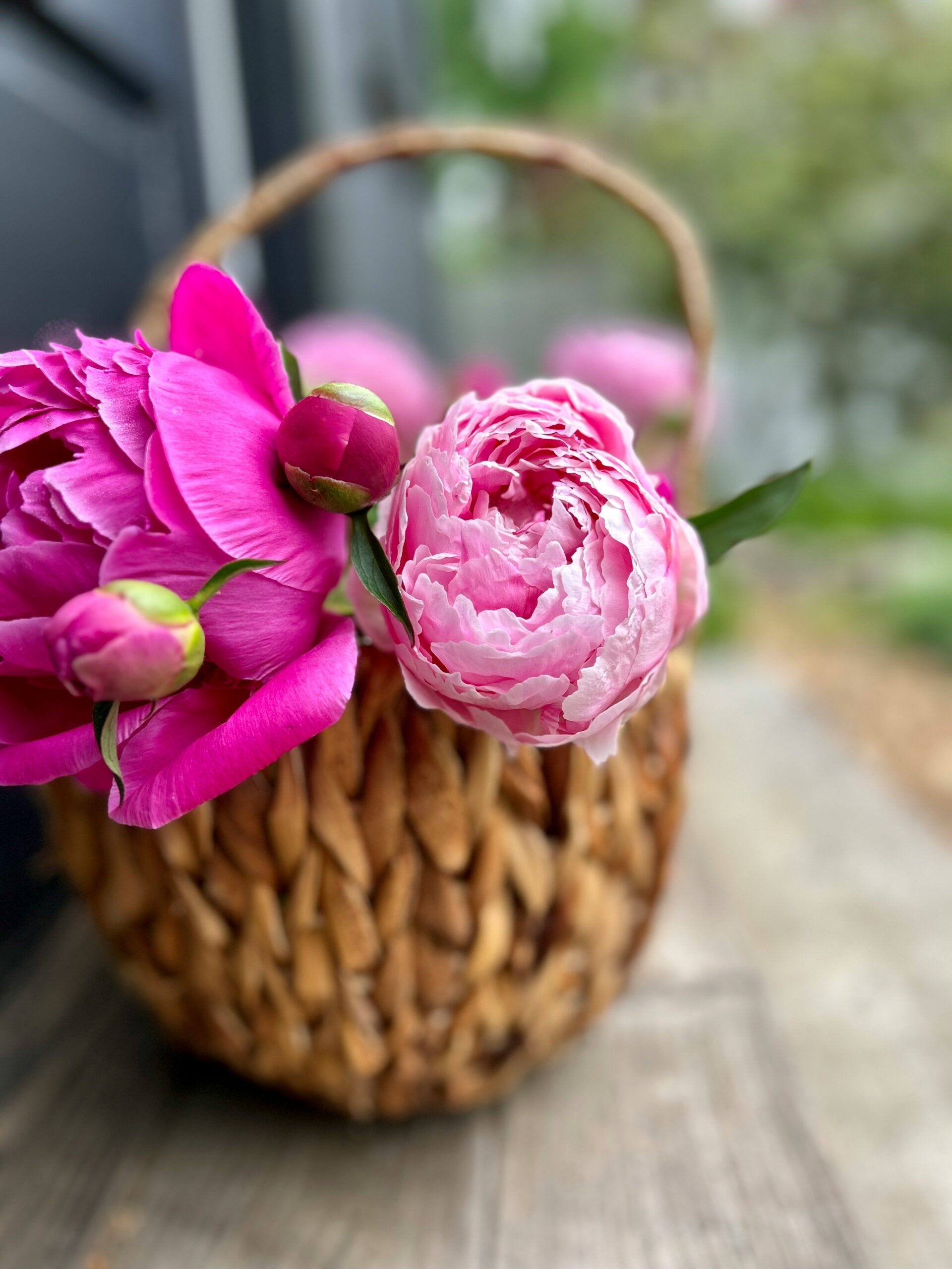 a basket filled with pink flowers sitting on top of a wooden tableAffordable Modern Farmhouse Decor Ideas for Every Budget