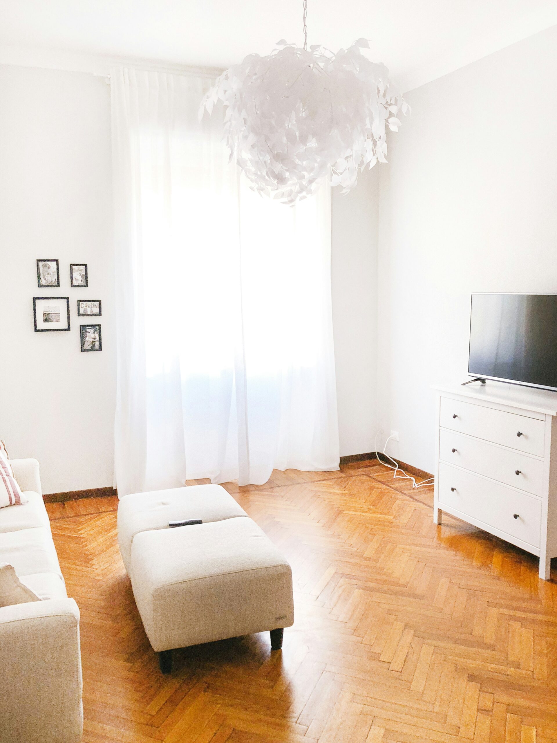 turned-off flat screen television on white dresserBest Affordable Home Decor for First-Time Renters