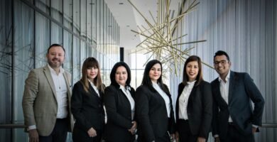 Professional working remotely on a laptop with AI data visualizations.